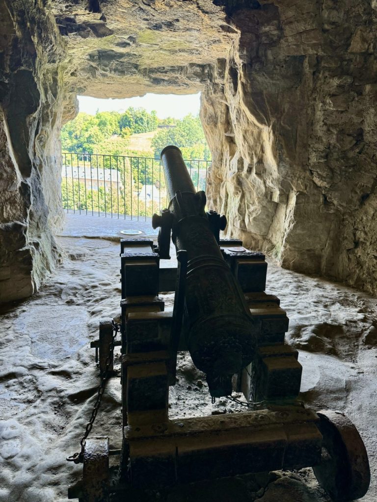 Vista dei tunnel sotterranei scavati nella roccia calcarea. Particolare interno con cannone